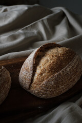 Artisan Batard Sourdough healthy Bread. Open crumb high hydration Sourdough french country bread set on dark background. - 587000158