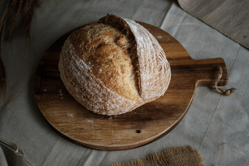 Artisan Batard Sourdough healthy Bread. Open crumb high hydration Sourdough french country bread set on dark background. - 587000159