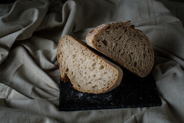 Artisan Batard Sourdough healthy Bread. Open crumb high hydration Sourdough french country bread set on dark background. - 587000161