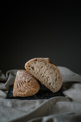 Artisan Batard Sourdough healthy Bread. Open crumb high hydration Sourdough french country bread set on dark background. - 587000176