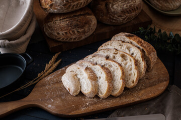 Artisan Batard Sourdough healthy Bread with leaf scoring. Open crumb high hydration Sourdough bread set on white table. - 587000187