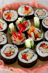 Homemade futomaki maki sushi rolls with vegetables and canned tuna fish.