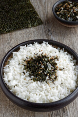 Rice with vegan furikake seasoning with torn nori seaweed on a top.