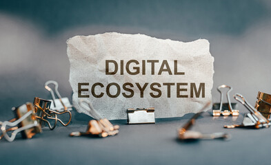 The words digital ecosystem on torn paper.