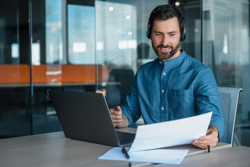 Male manager in headphones having a video call