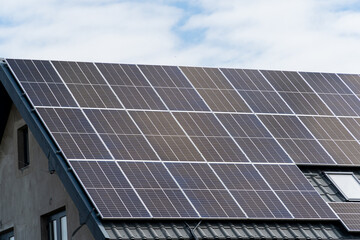 New solar panels installed on metal sheet roof of the house