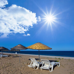 sun umbrella  with armchair on sandy sea beach at sunny day