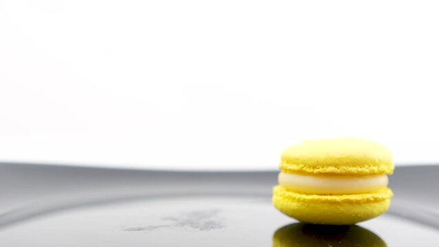 rose macaron with circles on background of pyramid with other sweets on white background female hand scrolls dessert making beautiful video of cooking delicious lunch macaroon spins on the table