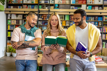 Group of people reading books in library