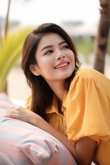 Happy woman lying down relaxing enjoying on sofa at the beach, lifestyle, generative AI