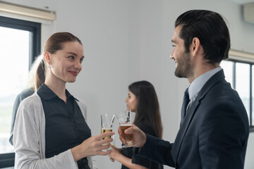 Business people drinking champagne to celebrate success of investment agreement after meeting, teamwork and partnership concept.