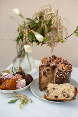 Traditional easter cake with nuts and dried fruits and chocolate drops inside and different sweets in bowl. Easter treat and holiday symbol