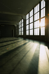 Spacious industrial interior with large windows on a sunny day