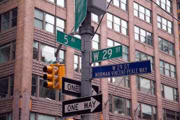 Fototapeta na wymiar Green West 29th Street and 5th Avenue Fashion traditional sign in Midtown Manhattan