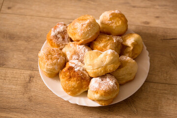 Ruddy fragrant donuts sprinkled with powdered sugar