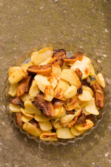 Crispy, ruddy fried potatoes with slices of fried lard