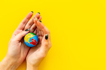 Fototapeta na wymiar Female hands holding globe. Save the Earth planet ecology concept.