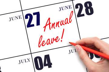 Hand writing the text ANNUAL LEAVE and drawing the sun on the calendar date June 27