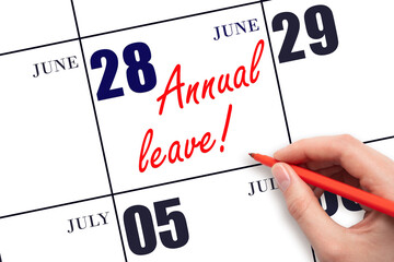 Hand writing the text ANNUAL LEAVE and drawing the sun on the calendar date June 28