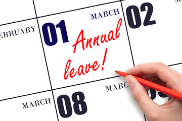 Hand writing the text ANNUAL LEAVE and drawing the sun on the calendar date March 1