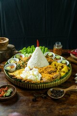 Nasi tumpeng rice happy birthday celebration with whole grilled chicken