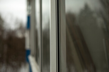 Window outside. Balcony window details. White plastic rail.