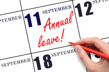 Hand writing the text ANNUAL LEAVE and drawing the sun on the calendar date September 11