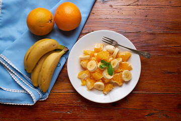 Sliced bananas and oranges