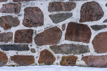 Stone wall background texture in winter.
