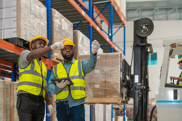 African workers holding folders for checking and inspecting on site warehouse area for shipping...