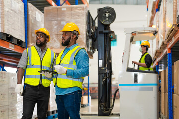 African workers holding folders for checking and inspecting on site warehouse area for shipping...