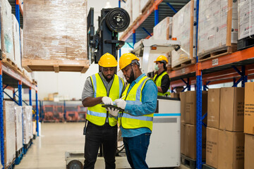 African workers holding folders for checking and inspecting on site warehouse area for shipping...