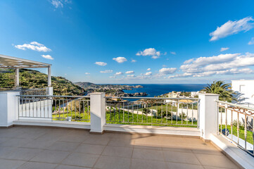 Fototapeta premium Panoramic sea view from a terrace or veranda. Summer day, blue sky ans sea. 