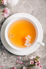 Tea with cherry blossom petals - Sakura tea in white cup