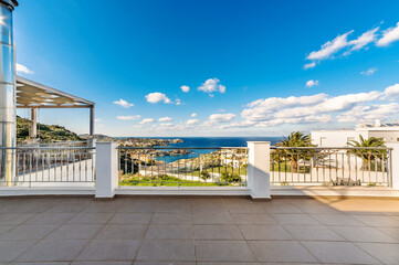Panoramic sea view from a terrace or veranda. Summer day, blue sky ans sea. Selective focus