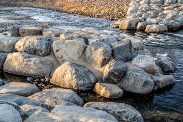 wave shaping rock structure exposed at low water in a whitewater park, Poudre River in Fort Collins, Colorado