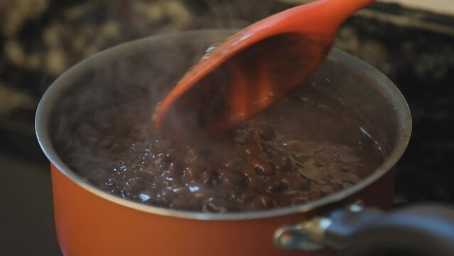 Preparing a pot of black beans on the stove at home. Feijoada.
