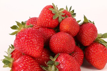 close up heap of fresh strawberries on white ground