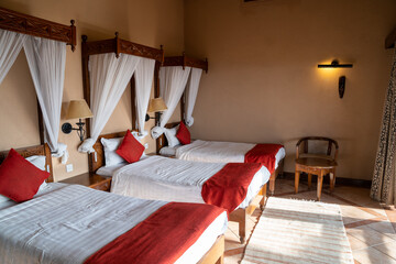 Typical safari lodge room, with three twin beds, in Kenya Africa