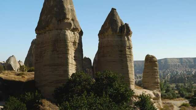 Close-up of sandstone cliffs in the form of phalos. Valley of Love in Cappadocia, a popular tourist destination in Turkey. Camera movement from top to bottom