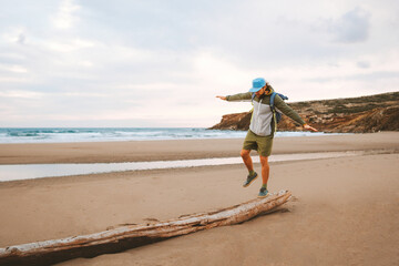 Man traveler walking alone on the beach travel lifestyle active summer vacations outdoor sea view