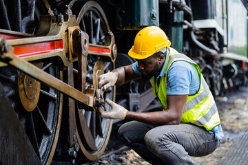 African engineer inspecting train wheels in train maintenance, safety first, factory inspection, railway engineer