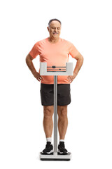 Mature man in sportswear standing on a medical weight scale