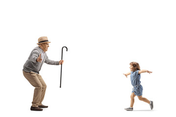 Little girl running to hug her grandfather