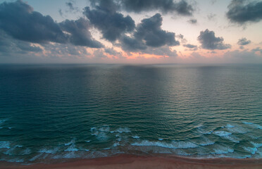Sea coast, aerial view. Clean sea, waves and sunset