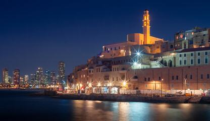 Night Jaffa and Tel Aviv skyline. Ancient city on mediterranean sea