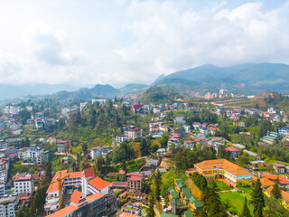 Fototapeta na wymiar Aerial view of landscape at the hill town in Sapa city, Lao Cai Province, Vietnam in Asia with the sunny light and sunset, mountain view in the clouds