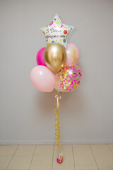 pink and gold balloons for a girl, the inscription on the balloon "Happy birthday"