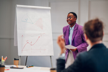 African american businesswoman holding a presentation during a meeting in an office