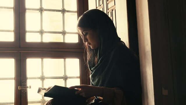 Muslim Woman Reading Koran In Mosque